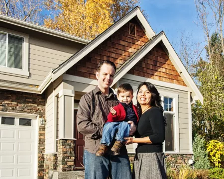 Family in front of their home in Autumn.